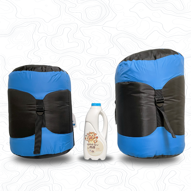 Scale image of two Domex Bushmate Synthetic Sleeping Bags on end - Blue. On left is small, on right is XL. In between is 1L bottle of milk for comparison | GENERAL