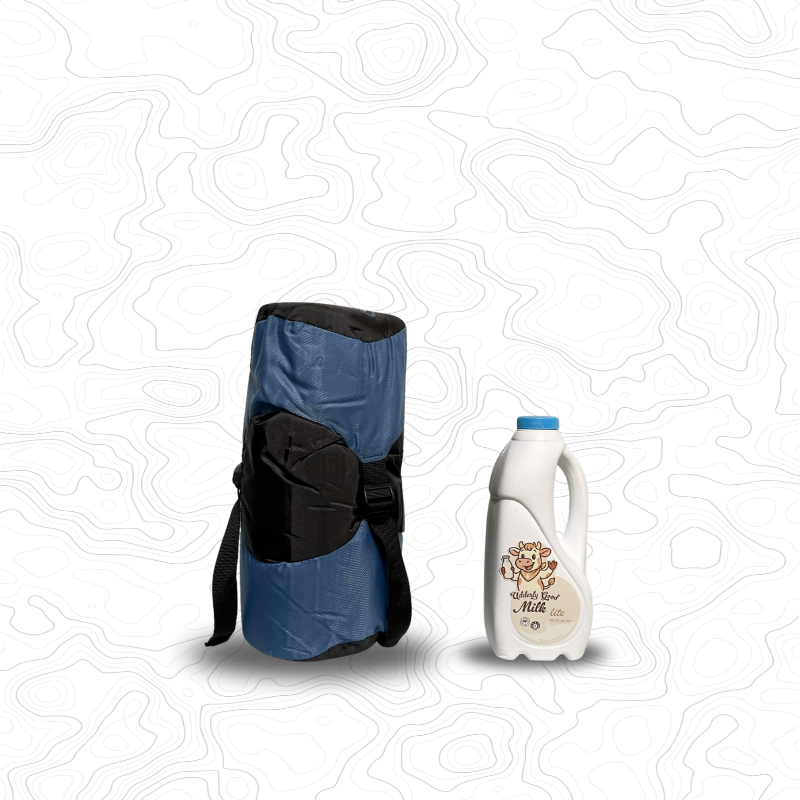Scale image of Domex Nimbus 100 Summer Sleeping Bag | Upright in stuff sack next to 1 L bottle of milk