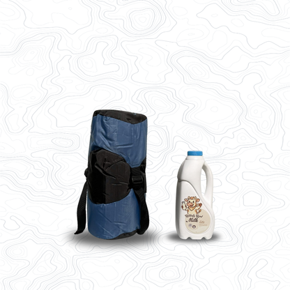 Scale image of Domex Nimbus 100 Summer Sleeping Bag | Upright in stuff sack next to 1 L bottle of milk