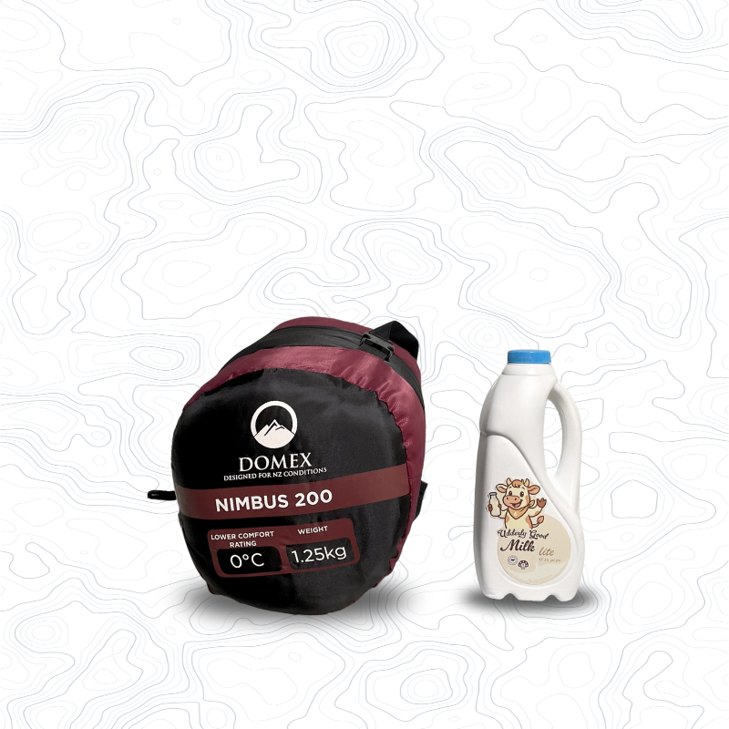 Scale image of Domex Nimbus 120 Sleeping Bag - 0C, 1.25kg  | On its side in stuff sack next to 1 L bottle of milk
