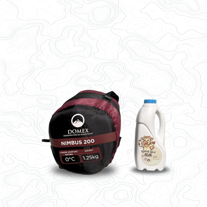 Scale image of Domex Nimbus 120 Sleeping Bag - 0C, 1.25kg  | On its side in stuff sack next to 1 L bottle of milk