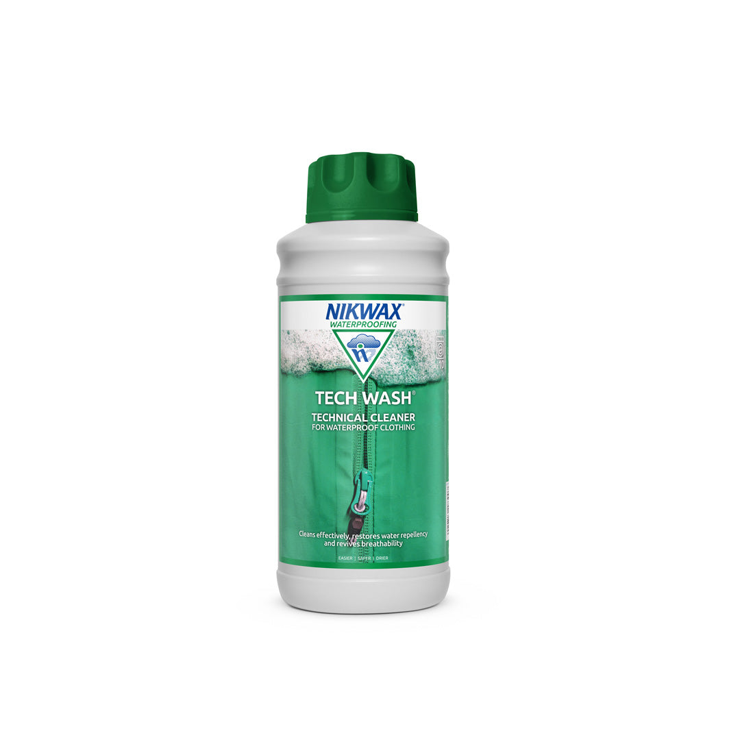 1 litre bottle of NikWax Tech Wash. Bottle is white with a green lid. Label features a close up image of a zippered green jacket with foam at the top of the label | NW183