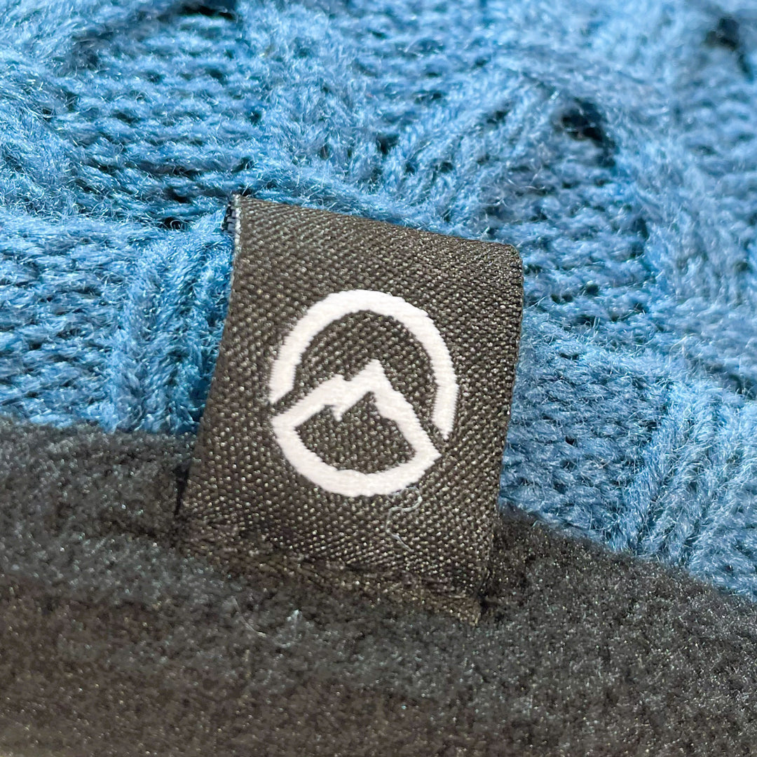 Close up of Domex logo on Honeycomb-knit cuffless beanie  - teal | DOMB1060