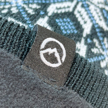 Close up of Domex logo on snowflake design cuffless knit beanie 