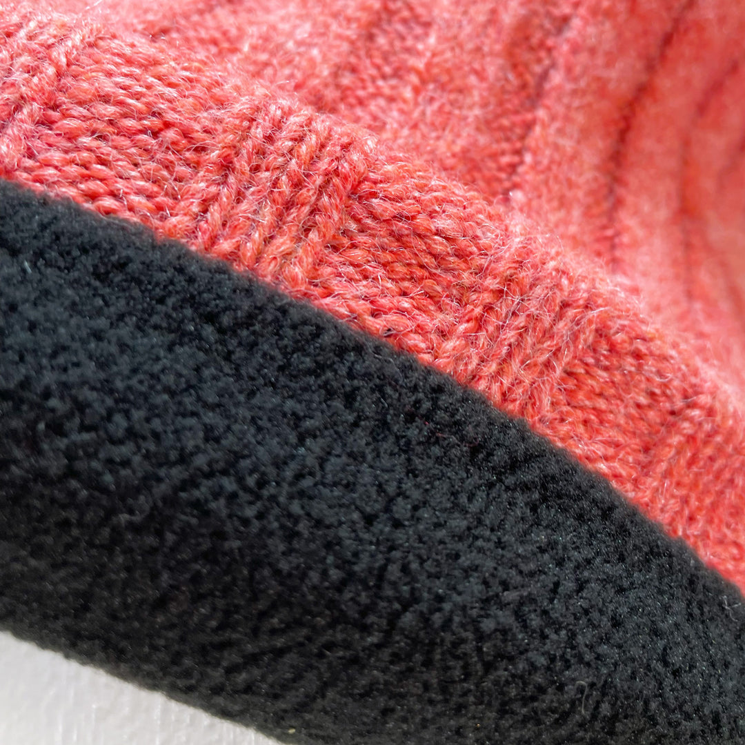 Close up of fleece lining of Domex Pink thick rib-knit cuffed beanie with fluffy faux-fur accent pom pom