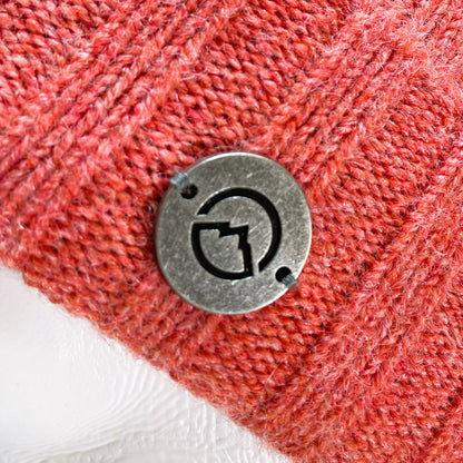 Close up of Domex Medallion on Pink thick rib-knit cuffed beanie
